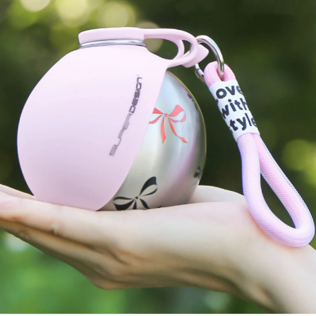 Midello portable dog water bottle being used by a small dog drinking on the go