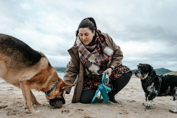 Woman with two dogs on a beach